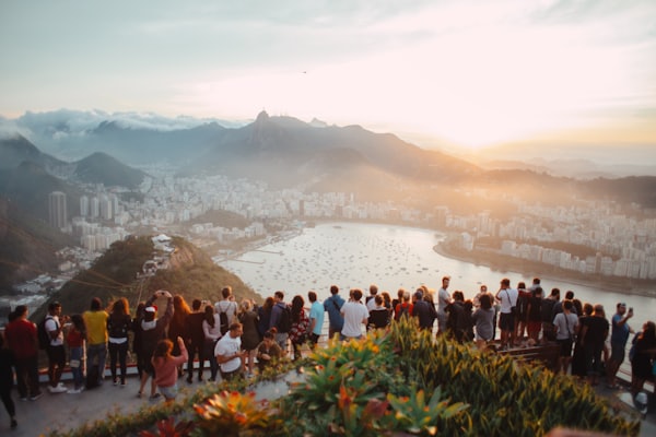 A group of travel friends watching the sunset together on a hike